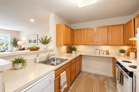 A kitchen with wooden cabinets and a white countertop.