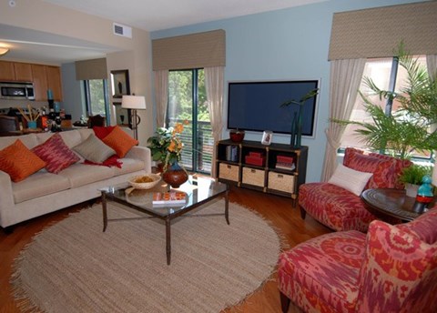 A living room with a couch, chairs, and a coffee table.