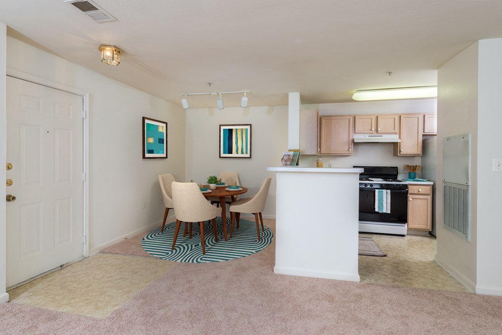 interior dining room and kitchen with oven, dining room table, and chairs at Governors Green, Bowie, MD, 20716
