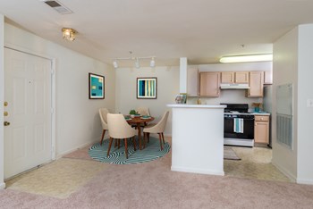 Governor's Green interior dining room and kitchen with oven, dining room table, and chairs - Photo Gallery 5