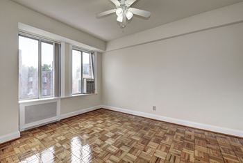 bedroom with ceiling fan and large windows at Park Crescent, Washington, DC
