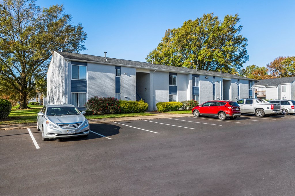 an office building with cars parked in front of it