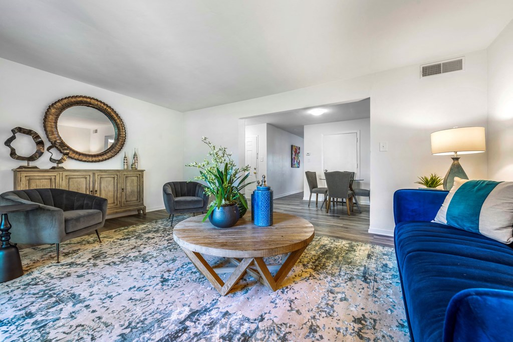 a living room with a blue couch and a coffee table