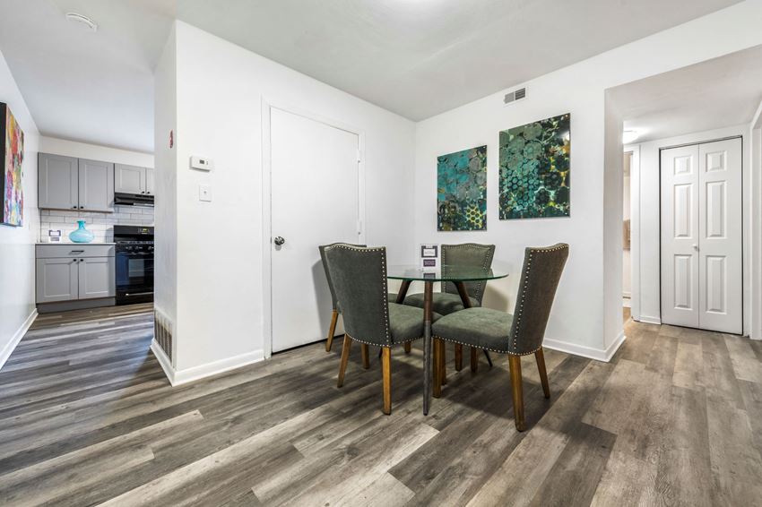 a dining room with a table and chairs and a kitchen