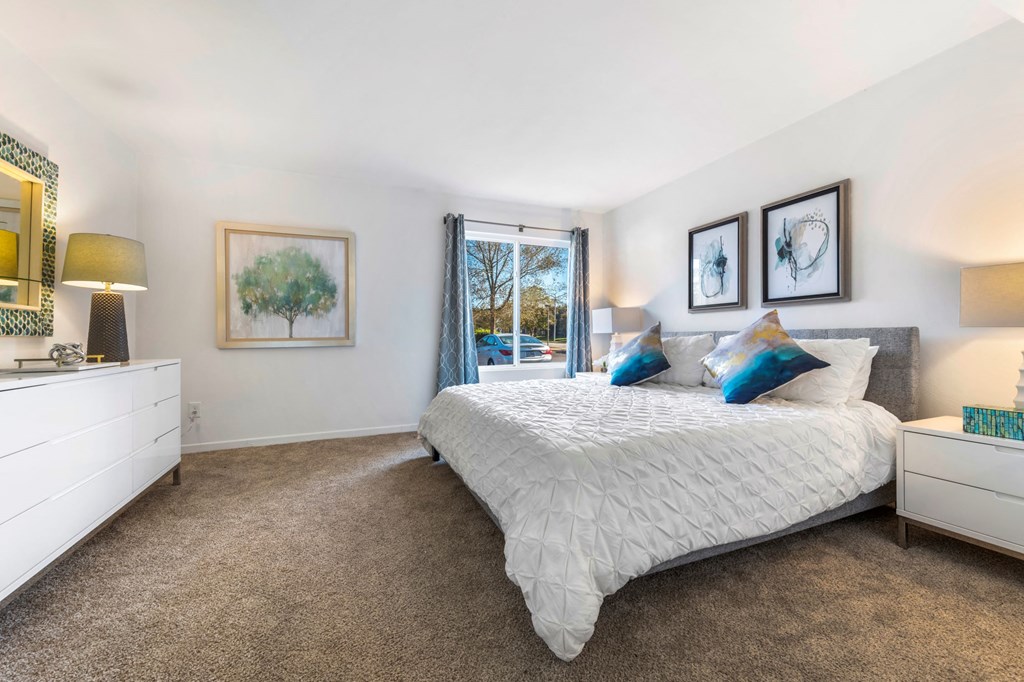 a bedroom with a bed and a window