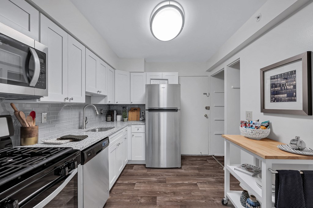 Kitchen with white cabinets and a stainless steel refrigerator at Aspen at Lake Trail, Columbia