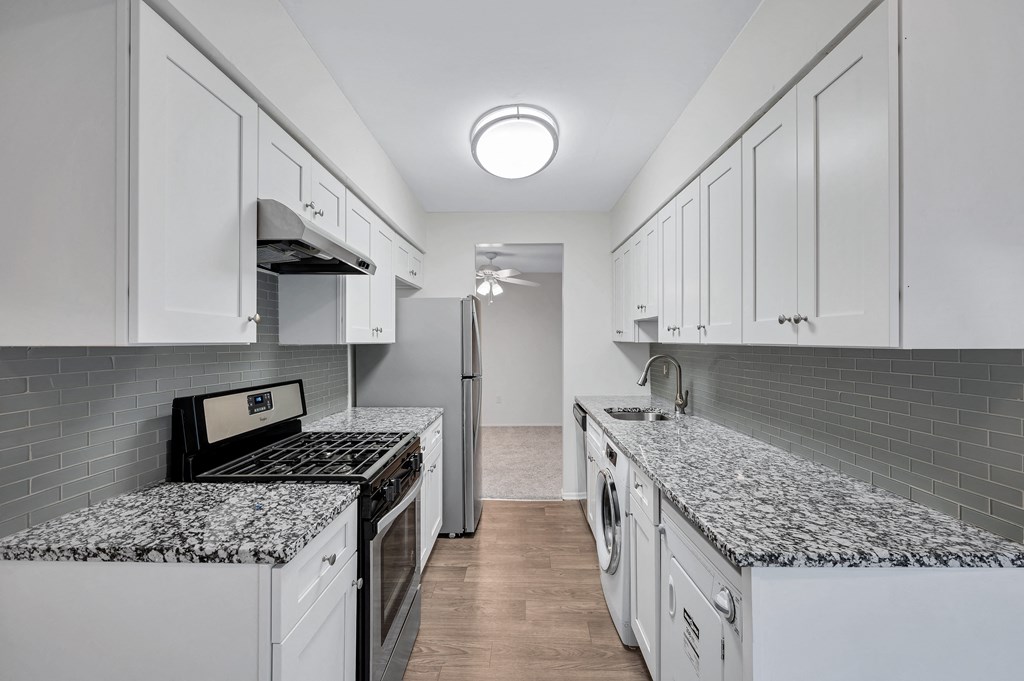 Kitchen with refrigerator and white cabinets at Aspen at Lake Trail, Maryland, 21045