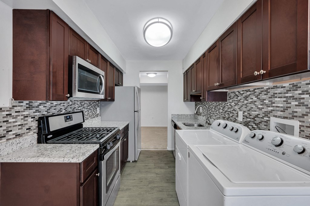 Kitchen With White Cabinetry And Appliances at Aspen at Lake Trail, Columbia, MD 21045