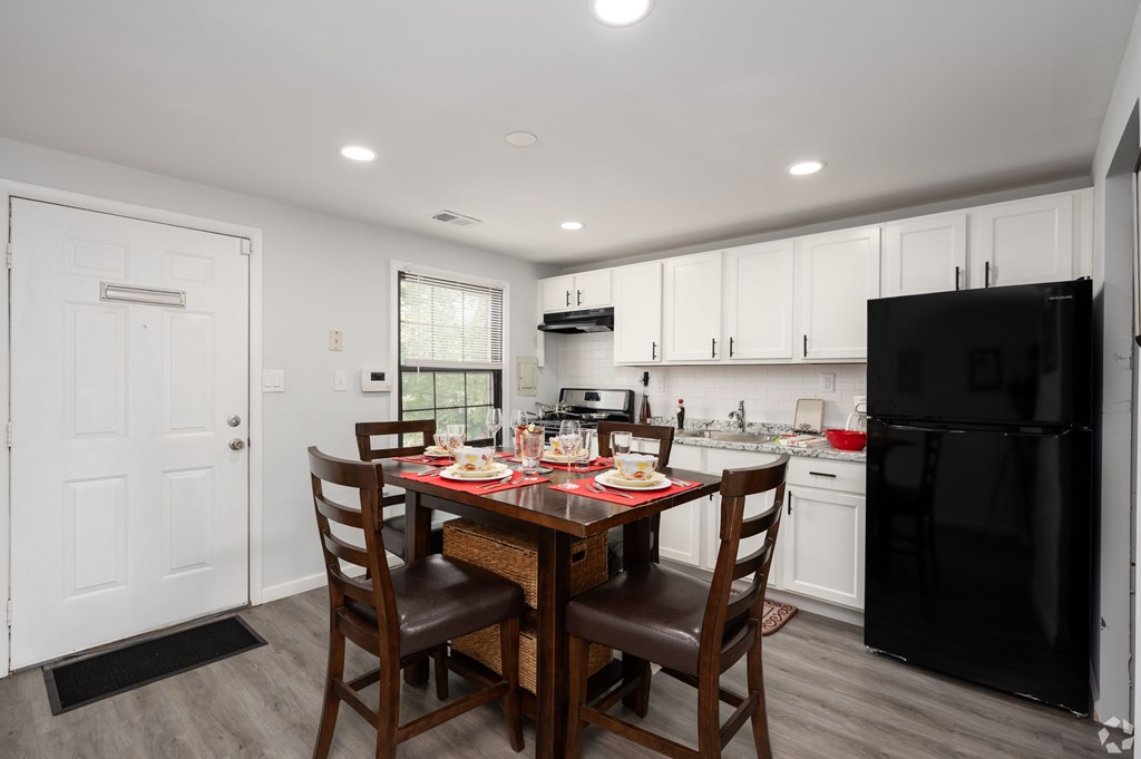 A kitchen with a table set for a meal.