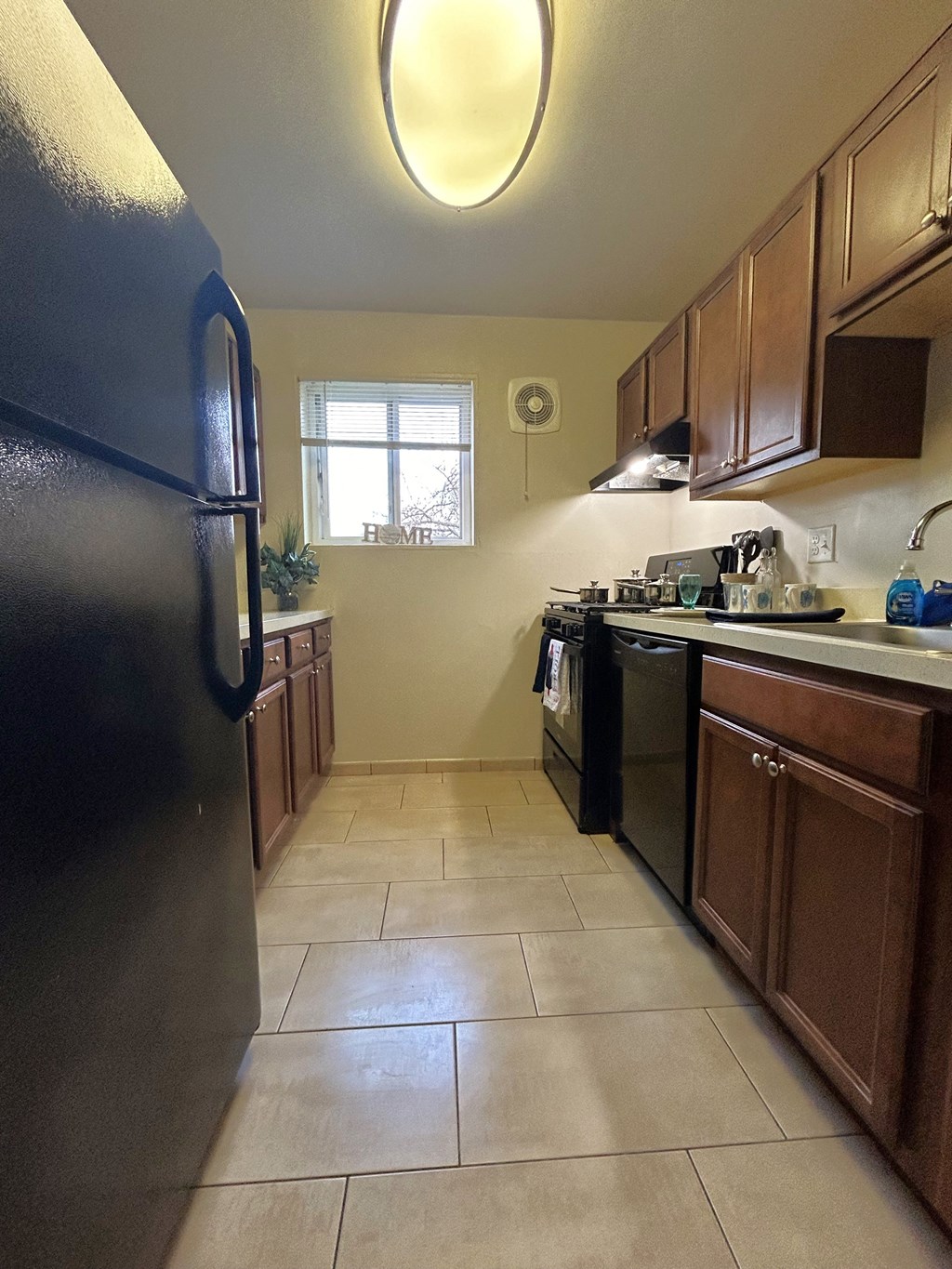 a kitchen with stainless steel appliances and wooden cabinets