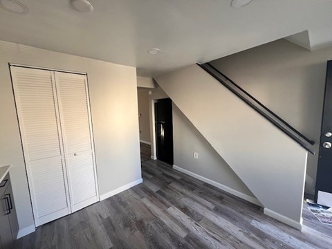 A room with a staircase leading to the upper floor at Pleasantview Apartments, Baltimore, MD, 21214