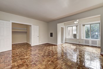 room with wood floors and white walls and doors at Park Crescent Apartments in Washington, DC