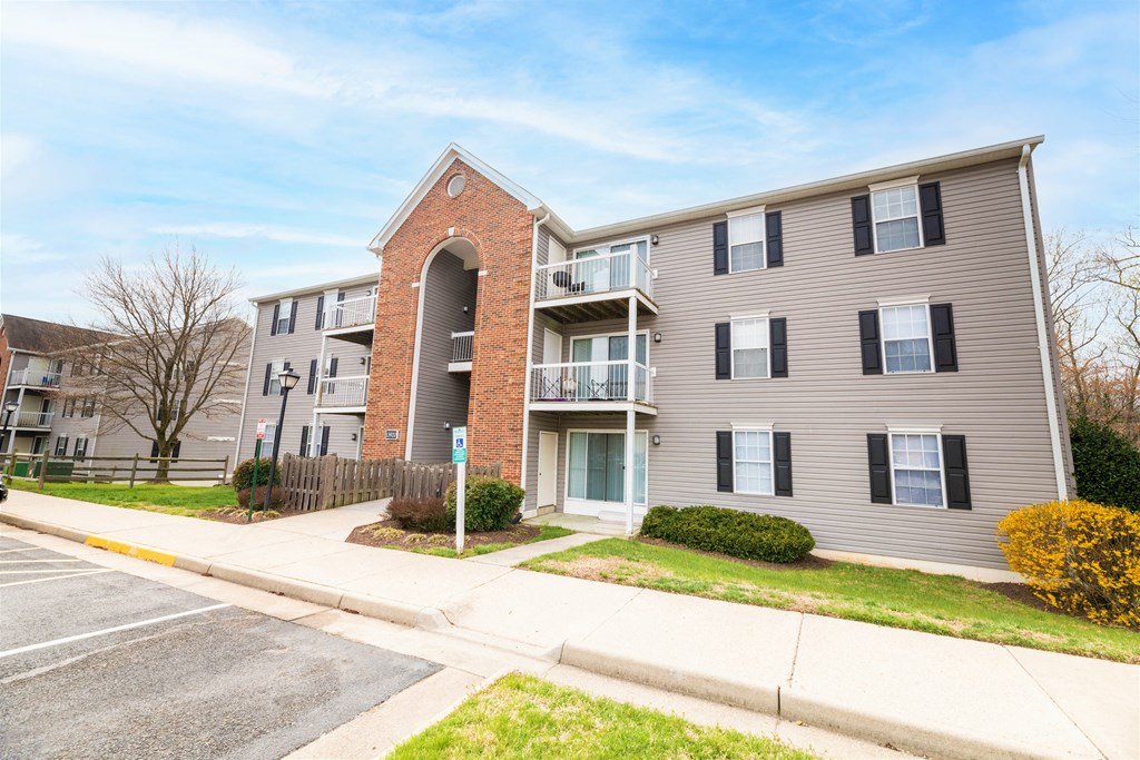 a picture of an apartment building with a sidewalk in front of it at BellaVista Apartments in Woodbridge, VA