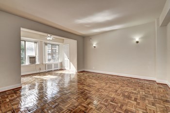living room with wood floors and large windows at Park Crescent Apartments in Washington, DC