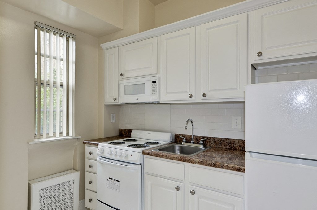 Kitchen With White Cabinetry And Appliances at Majestic, Washington