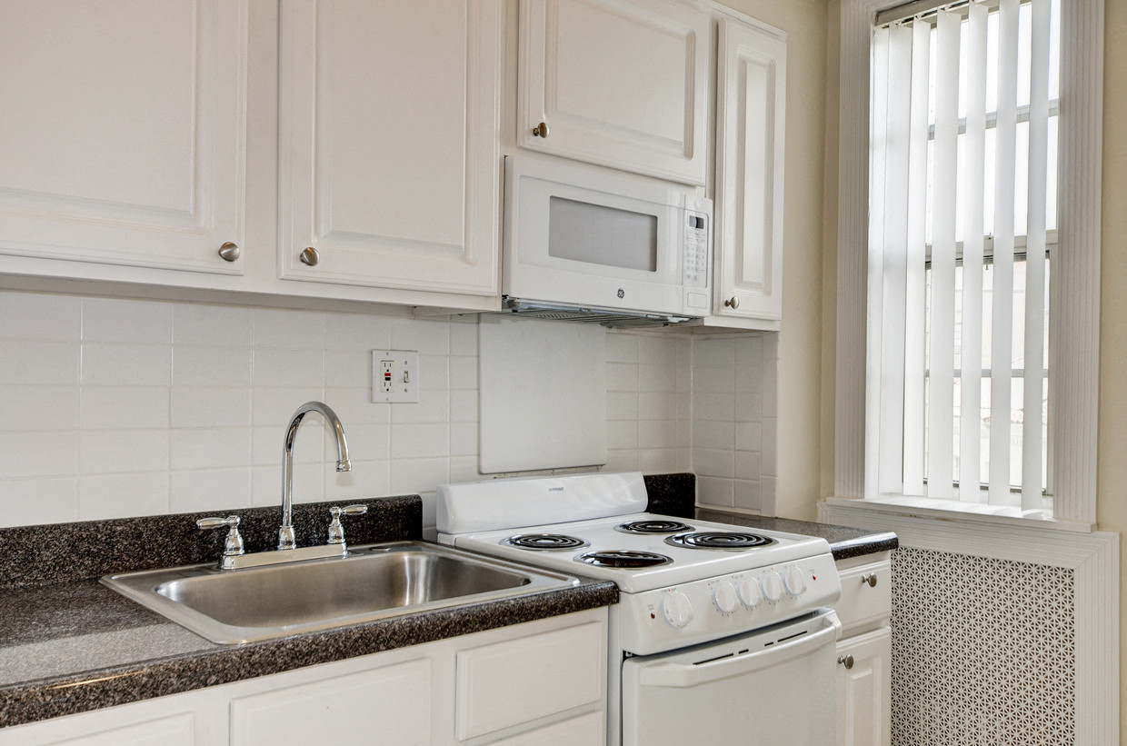 a kitchen with white appliances and white cabinets