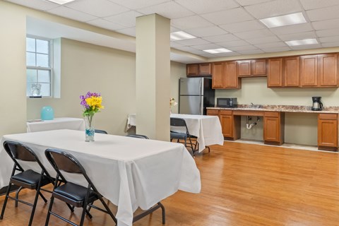 A dining area with a table set for two.