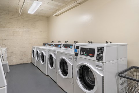 A row of washing machines in a laundromat.