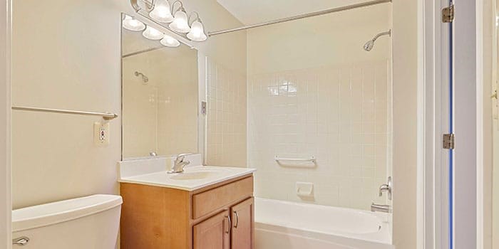 A bathroom with a white tub, sink, and shower. at Rainier Manor Apartments, Maryland
