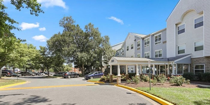 A white building with a yellow line in front of it. at Rainier Manor Apartments, Mount Rainier, MD