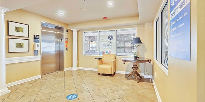 A hallway with a blue sign on the wall at Rainier Manor Apartments, Mount Rainier, Maryland