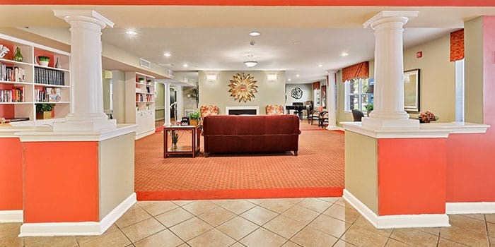A living room with a fireplace and a bookcase at Rainier Manor Apartments, Mount Rainier, MD, 20712