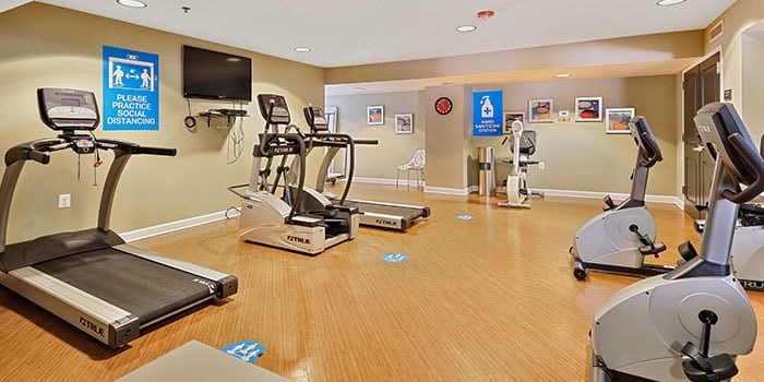 A gym with treadmills, elliptical machines and other exercise equipment. at Rainier Manor Apartments, Mount Rainier, MD