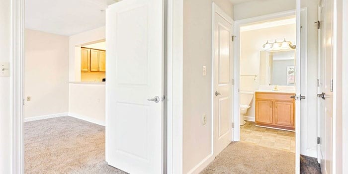 A white door is open to a bathroom. at Rainier Manor Apartments, Maryland