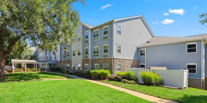 A large apartment complex with a green lawn in front at Rainier Manor Apartments, Mount Rainier, MD