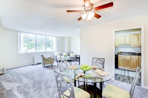 A dining room with a glass table and chairs.