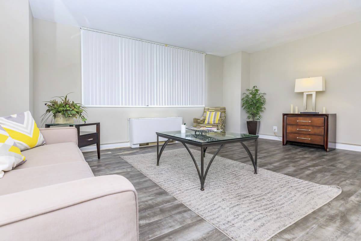 A living room with a glass table and a couch.