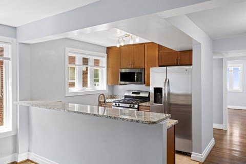 a kitchen with wood cabinets and a granite counter top