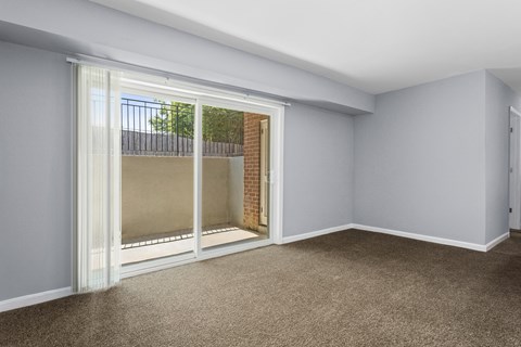 a bedroom with a large window and a balcony