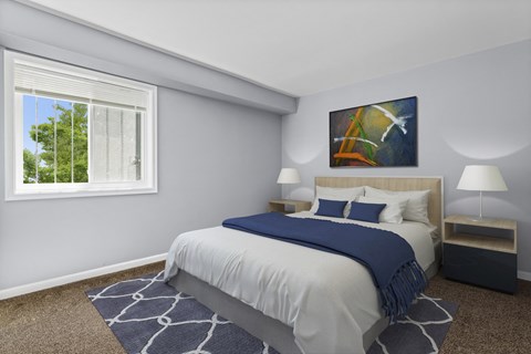 A bedroom with a large bed and a painting on the wall.