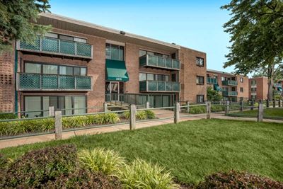 building exterior of Grandview apartments in Falls Church VA with walking path and grass out front