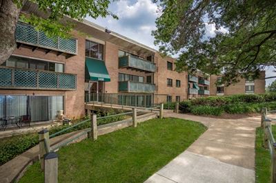 building exterior of Grandview apartments in Falls Church VA with walking path and grass out front