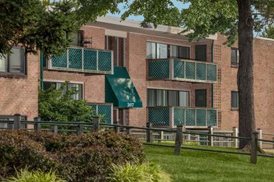 building exterior of Grandview apartments in Falls Church VA with walking path and grass out front