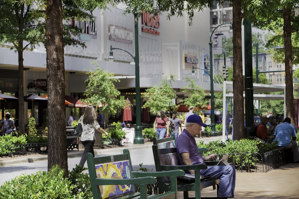 Man Sitting In A Park at Metro 710, Silver Spring