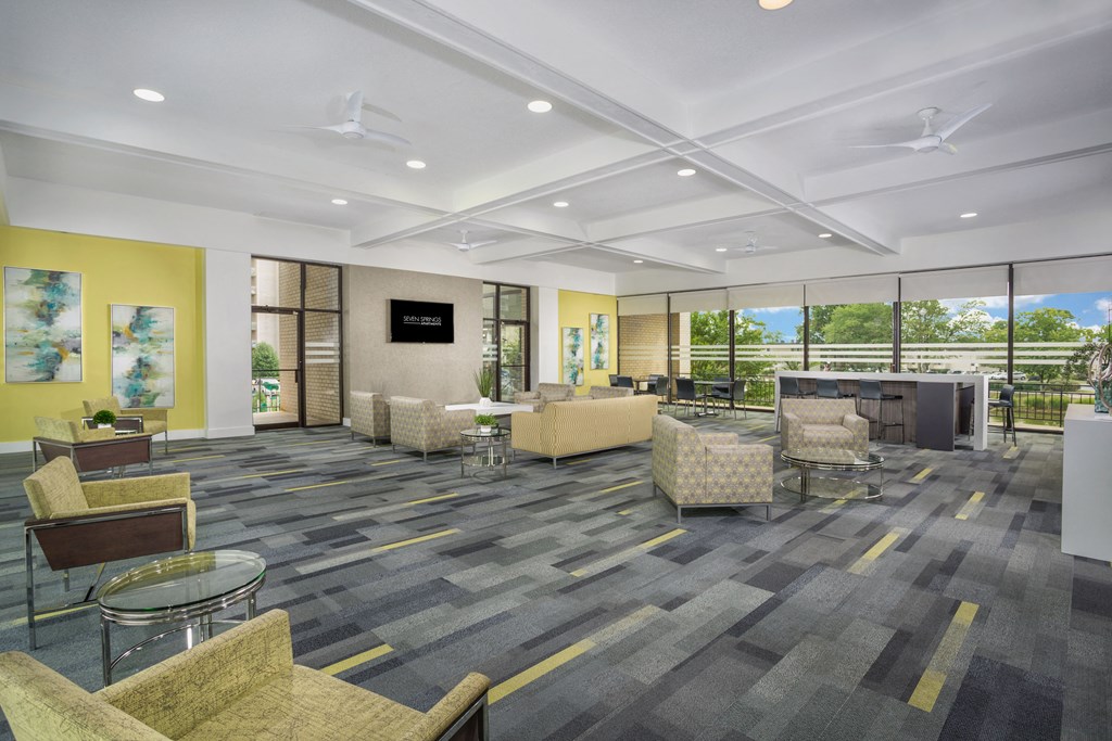 community space with gray carpeting and light green lounge chairs  at Seven Springs Apartments, College Park, MD