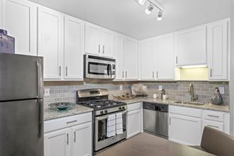Modern Kitchen With Stainless Steel Appliances And Double Door Refrigerators at Versailles Apartments, Towson, 21204