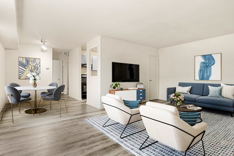 A living room with a white table and blue couch.