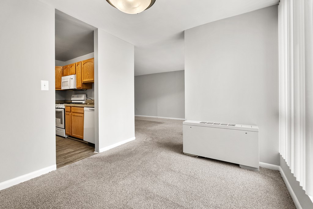 A white room with a white appliance and a white wall.