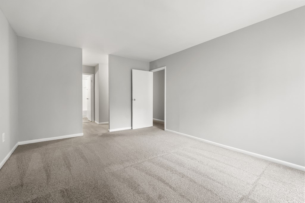 A room with a carpeted floor and white walls.