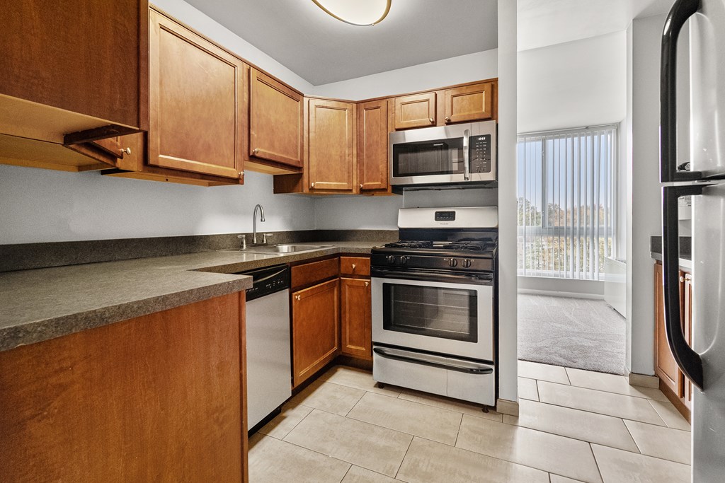 A kitchen with wooden cabinets and stainless steel appliances.