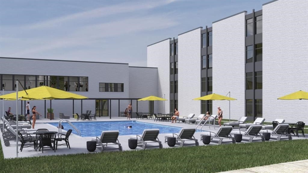 a rendering of the pool area of a building with chairs and umbrellas at The James On Merrimac, Williamsburg, 23185