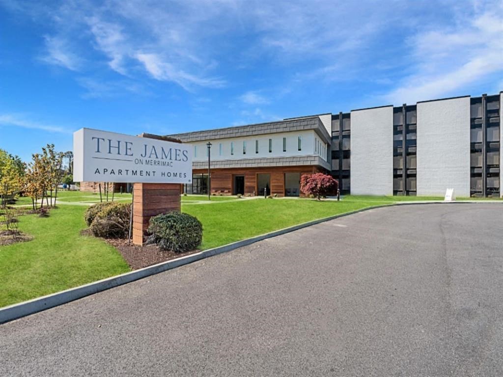 an image of the apartments sign in front of the building at The James On Merrimac, Virginia, 23185
