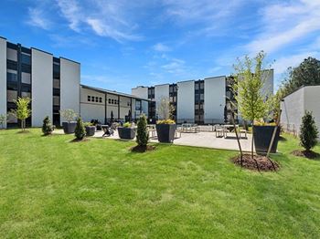 the courtyard of a building with grass and trees