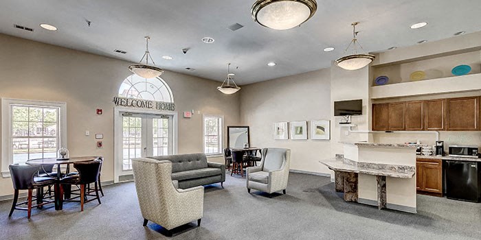 the lobby of a clubhouse with a bar and chairs at Windsor Crossing, Maryland 