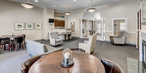 a living room with a table and chairs and a kitchen