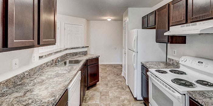 a kitchen with a stove and a refrigerator at Windsor Crossing, Suitland, MD 20746 